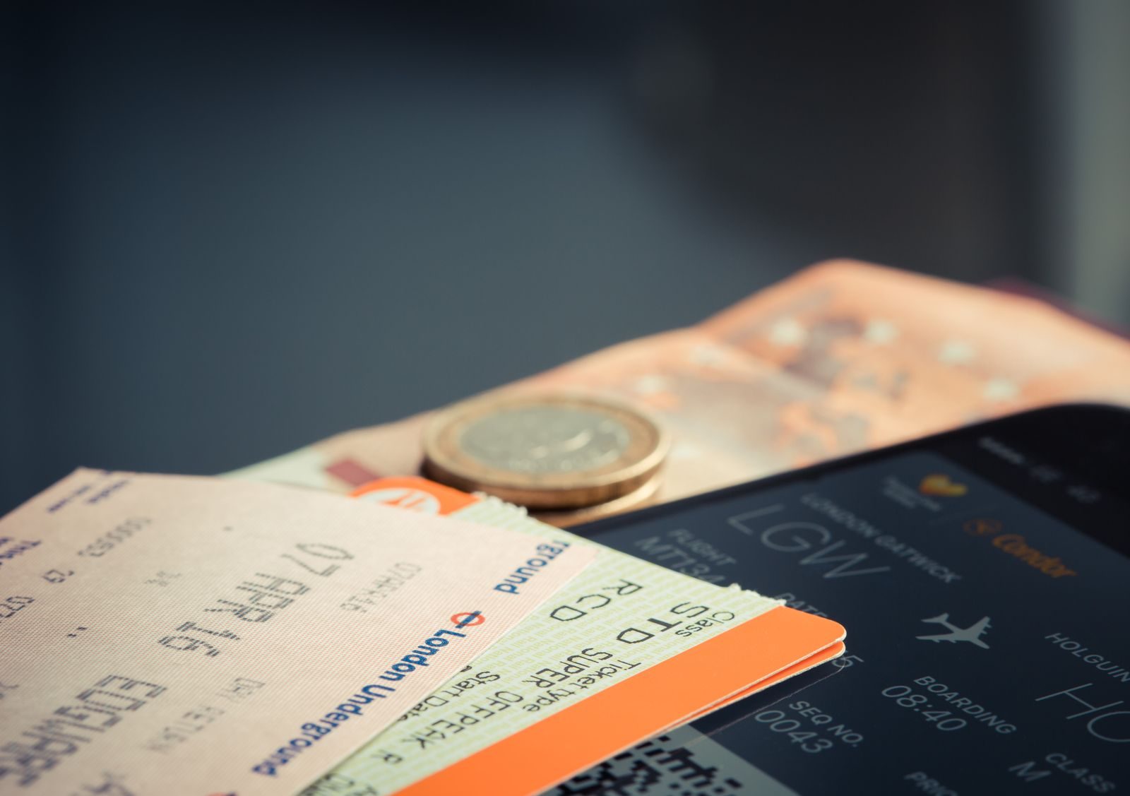 Travel documents, coins and boarding passes on a table