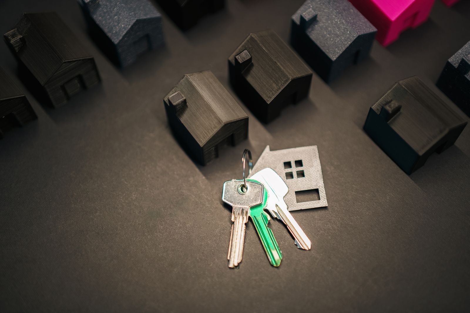 House keys resting beside small model houses